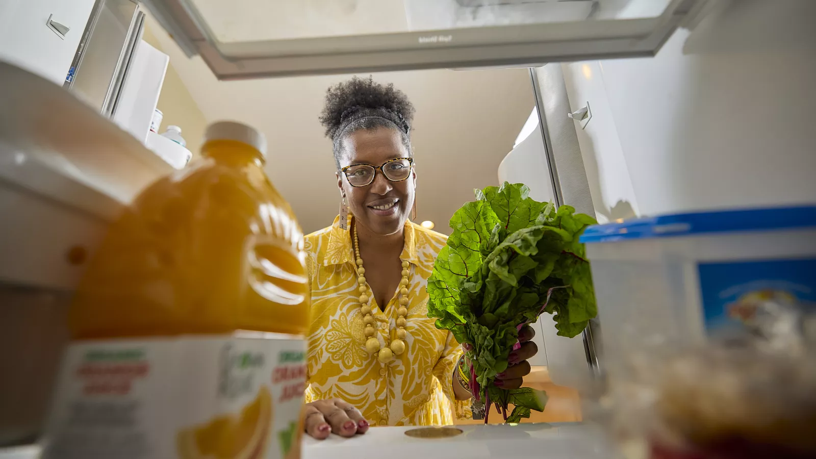 Tamara Russell looking into refrigerator