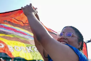Attendee at the Freedom to Learn Rally in Orlando holds up banner art