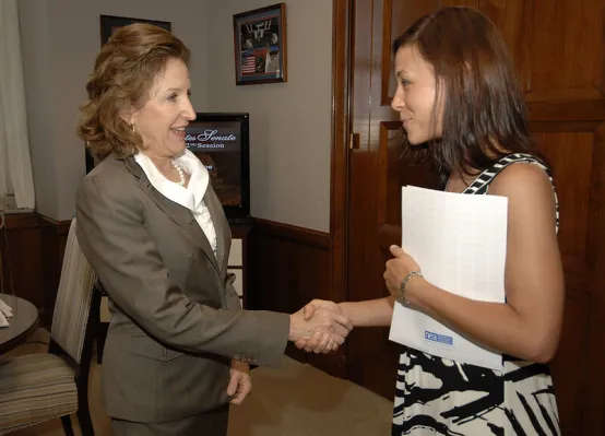 Photo of NC teacher Gina Frutig shaking NC Sen Kay Hagan's hand