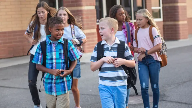 young students walking outside school